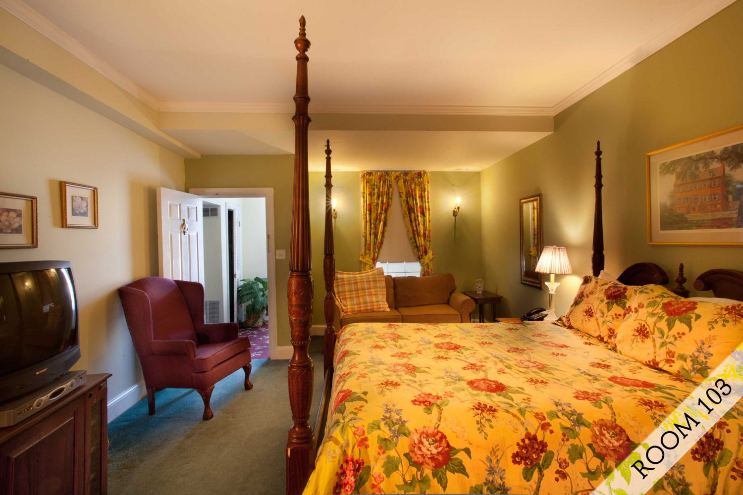 Interior photo of a classically decorated room with crystal chandelier and marble fireplace