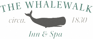 whalewalk inn logo featureing a silhouette of a humpback whale